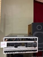 Front view of Magnavox stereo component with dual cassette decks and control knobs, showing the overall system condition.