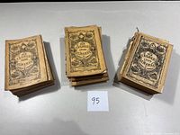 Three stacks of vintage Old Farmers Almanacs ranging from 1930 to 1959, showing worn covers and visible age.