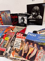 Front view showing magazines (Life, Post, Beatles), books (Clapton, Shakey) and Hohner pouch