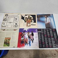 Back sleeve of Quicksilver, back of Poco, back of J.D. Souther, back of Redwing, front of Redwing group LP and back of unidentified LP