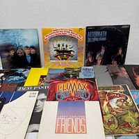 Group shot of assorted LPs highlighting Beatles, Rolling Stones, Jaco Pastorius, Climax Blues Band, Larry Carlton covers