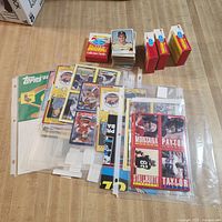 Overall view of cards, binder pages, loose stack and sealed boxes