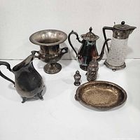 Group shot of all seven silverplate items