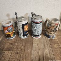 Front view of four ceramic beer steins