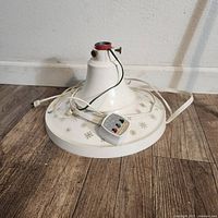 Top view of tree stand showing base, collar, control switch and cord