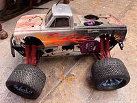 RC monster truck chassis showing body, tires, shocks
