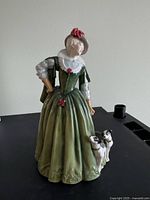Full front view of the Anne of Denmark figurine with dogs