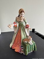 Front view showing gown, book and dog on pedestal