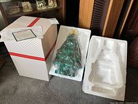 Porcelain Christmas tree in original box with styrofoam packaging and certificate.