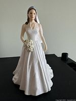 Front view of the Royal Doulton Catherine Royal Wedding Day figurine showing the detailed gown, bouquet, and tiara with veil.