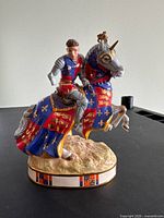 Front view of the Henry V knight figure missing one hand, mounted on a decorated horse with heraldic colors.