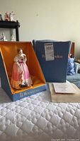 Figurine and original blue presentation box with paperwork laid out