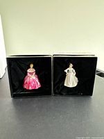 Two Royal Doulton miniature ladies figurines in original boxes with black satin interiors.