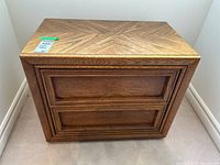 Front view of wood veneer nightstand showing two drawers and wood grain top.