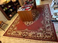 Full view of the machine woven rug laid on tiled floor with furniture around it for scale.