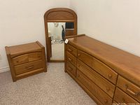 Dresser, nightstand, and mirror shown together, wood medium oak finish with rustic style.