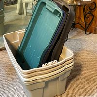 Stacked beige totes with assorted lids nested together