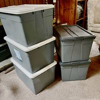 Five grey storage totes stacked, showing quantity and lid colors