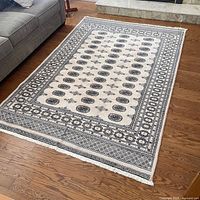 Full view of rug beside sofa showing overall design and size