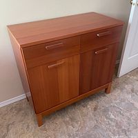 Front view of cabinet showing drawers, doors, handles