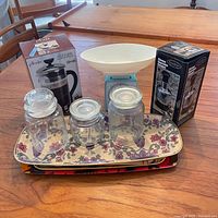 Group shot showing boxed French press, boxed vegetable chopper, kitchen scale, four jars, three nested trays