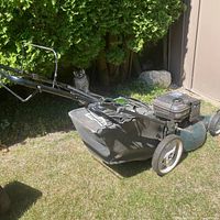 Left side view of entire mower showing grass catcher and handle