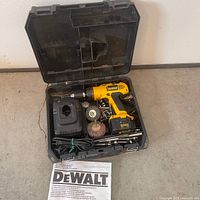Full kit in case: drill, charger, battery, attachments, manual