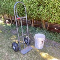 Full view Milwaukee hand truck and white bucket outdoors