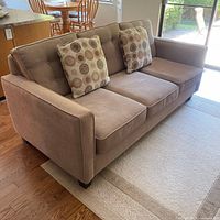 Front view showing full sofa and accent pillows