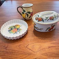 Overview of three fruit-themed serving pieces on table