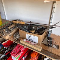 Overview of box containing planes, files, caulking tube and surrounding tools