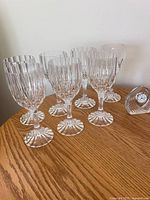 Group of six crystal wine glasses and Waterford clock on table