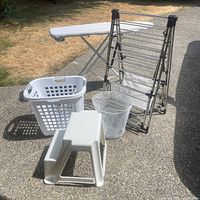 All five items grouped: drying rack, ironing board, stool, laundry basket, wastebasket