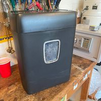 Front view of black Insignia shredder showing bin and viewing window