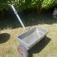 Full view of Lawncrafter spreader showing hopper, handle and wheels