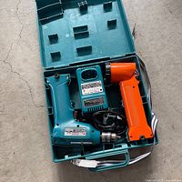 Open carry case showing drill, charger, angle drill, chuck