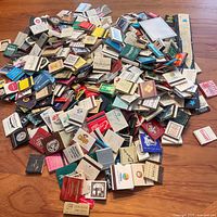 Pile of assorted matchbooks spread on floor