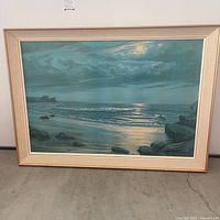 Full view of framed seascape art with moonlight reflection