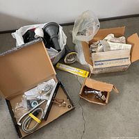 Overview of all plumbing items including faucet box, Kohler box, PVC parts, valve fittings, tape, accessory