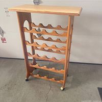 Full front view of wooden wine rack with five tiers and top shelf