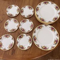 All fourteen Royal Albert Old Country Roses plates arranged on table