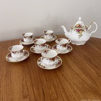 Teapot, six teacups and six saucers displayed on tabletop