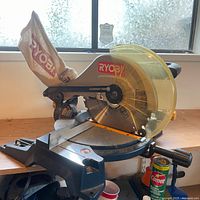 Full view of Ryobi saw showing blade guard, dust bag and base