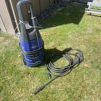 Full view of Simoniz pressure washer with hose and wand on lawn