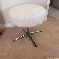 Full view of stool showing round faux fur seat and chrome base