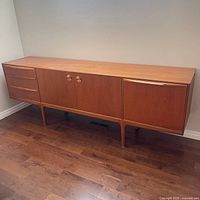 Full view of teak sideboard showing drawers, doors, legs