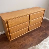 Front view of six-drawer teak dresser