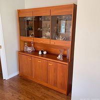 Full view of teak hutch showing both upper glass display section and lower cabinet
