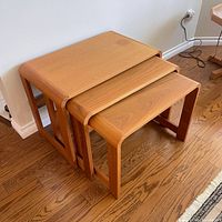 Set of three teak nesting tables stacked