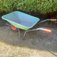 Full side view of green wheelbarrow